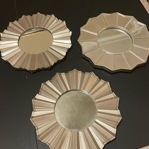 Three hanging mirrors